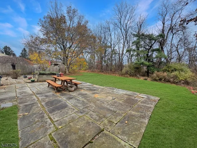 a view of a backyard with table and chairs and a fire pit