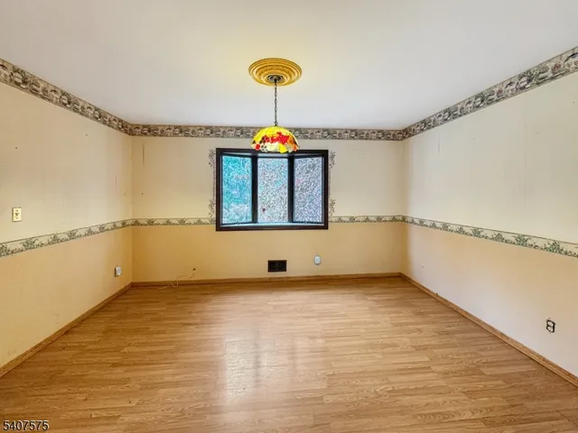 a view of a room with window and wooden floor