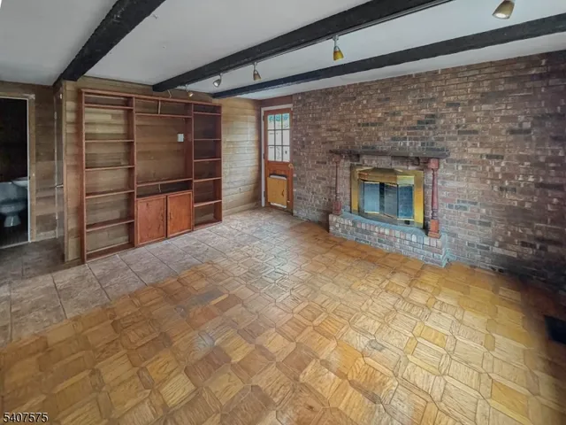 a view of empty room with a fireplace