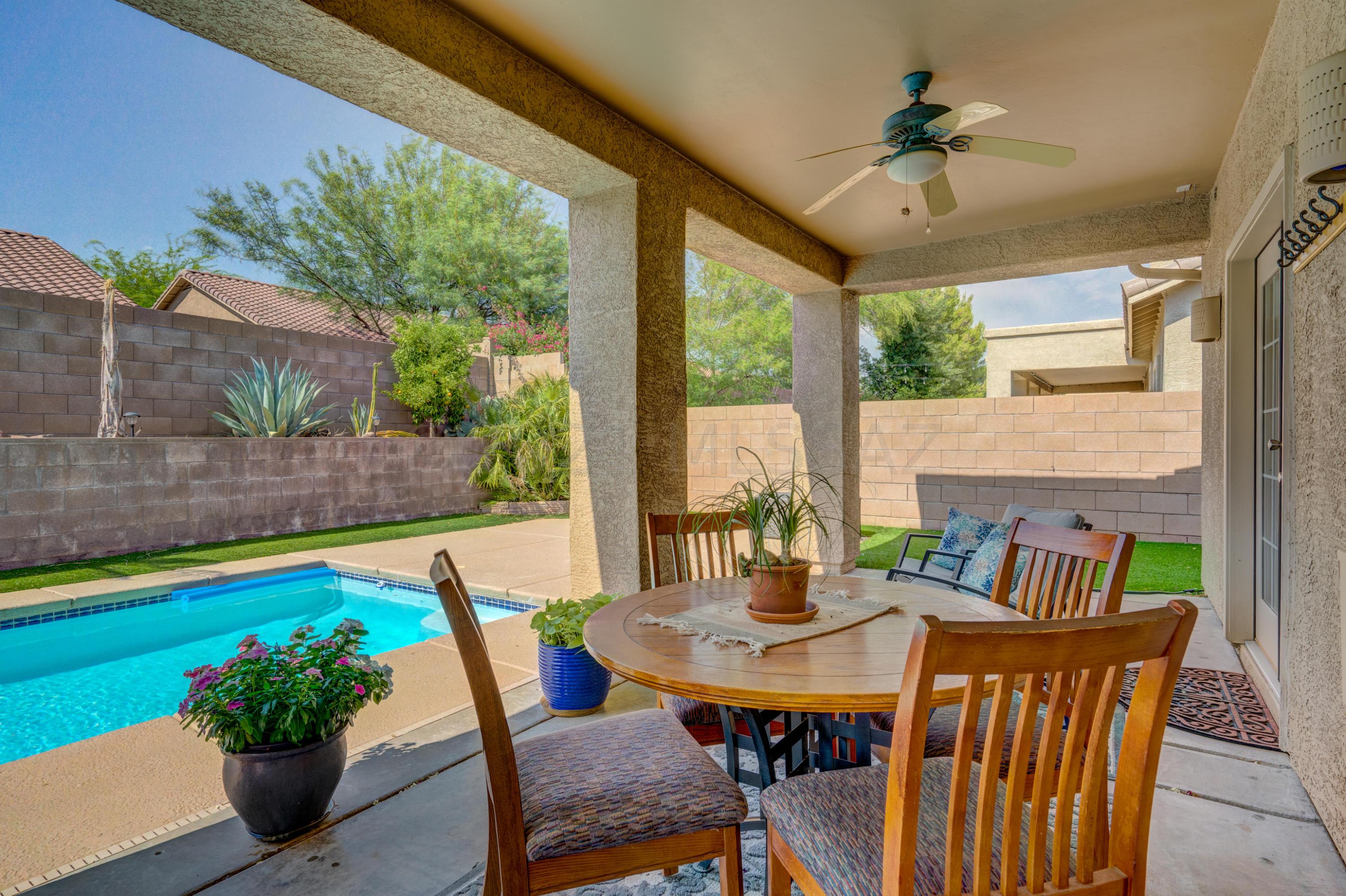 3639 East Northern Dancer Road Tucson, AZ 85739 - Photo 38 of 48 a view of an outdoor dining space with furniture and wooden floor