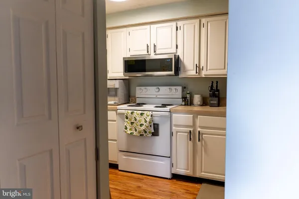 a kitchen with stainless steel appliances white cabinets and a sink