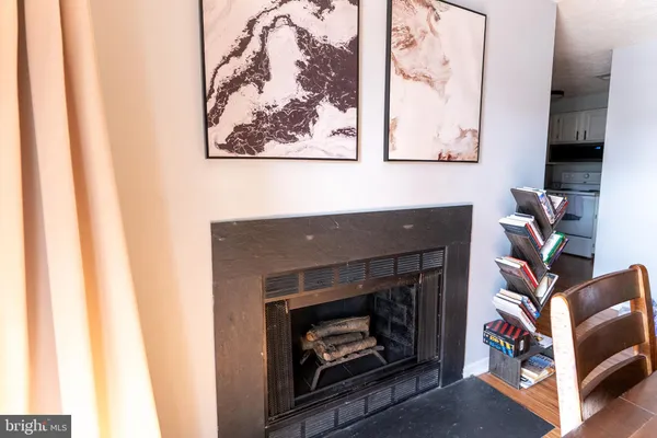 a living room with a fireplace and a painting on the wall