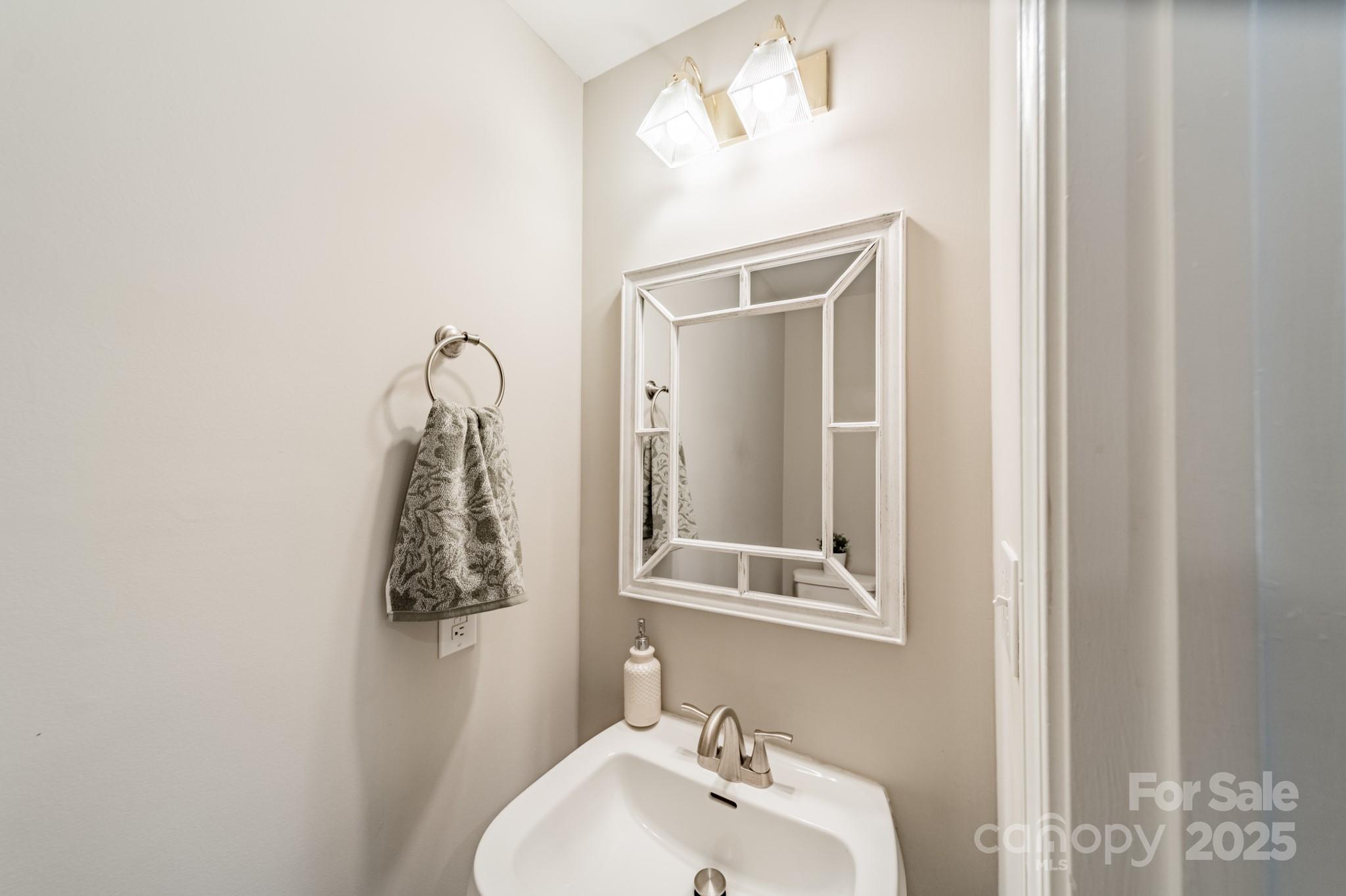 16104 Hollingbourne Road Huntersville, NC 28078 - Photo 14 of 40 a bathroom with a sink and a mirror