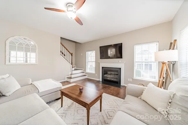 a living room with furniture a fireplace and a flat screen tv