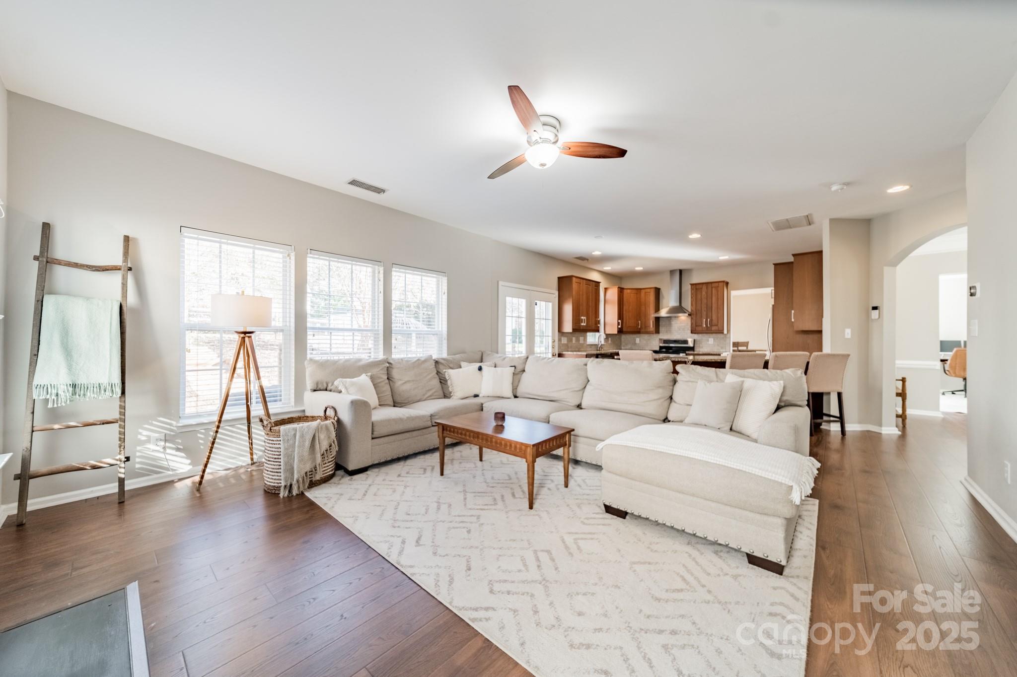 16104 Hollingbourne Road Huntersville, NC 28078 - Photo 18 of 40 a living room with furniture and a large window with wooden floor