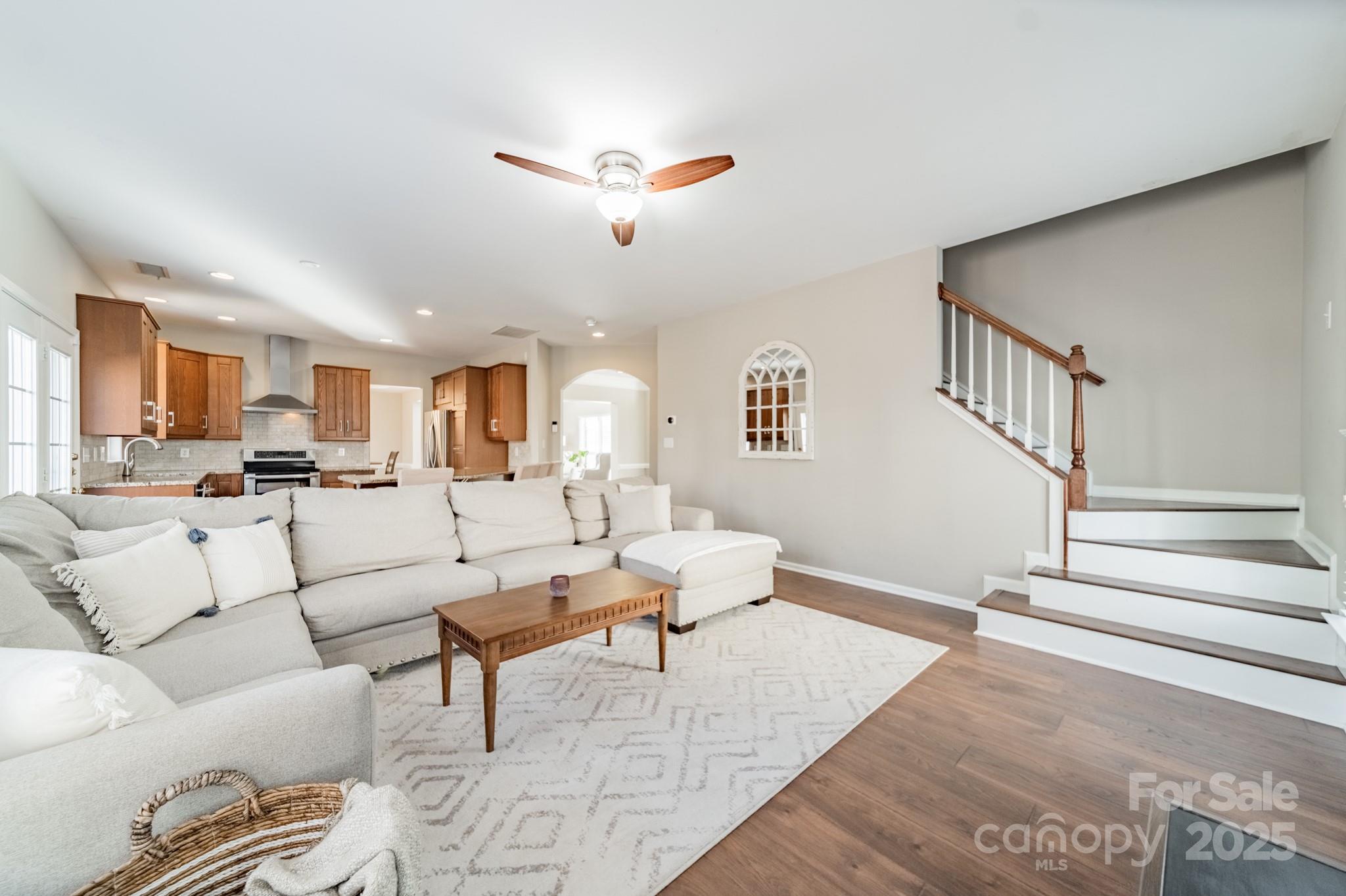 16104 Hollingbourne Road Huntersville, NC 28078 - Photo 19 of 40 a living room with furniture kitchen view and a wooden floor