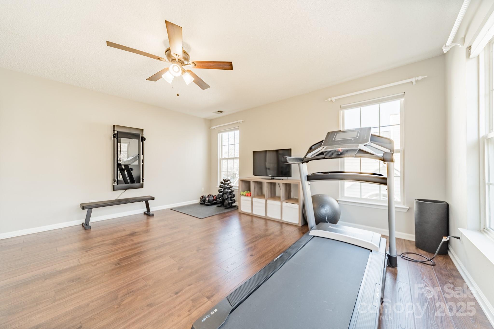 16104 Hollingbourne Road Huntersville, NC 28078 - Photo 26 of 40 a view of a livingroom with furniture a ceiling fan and window