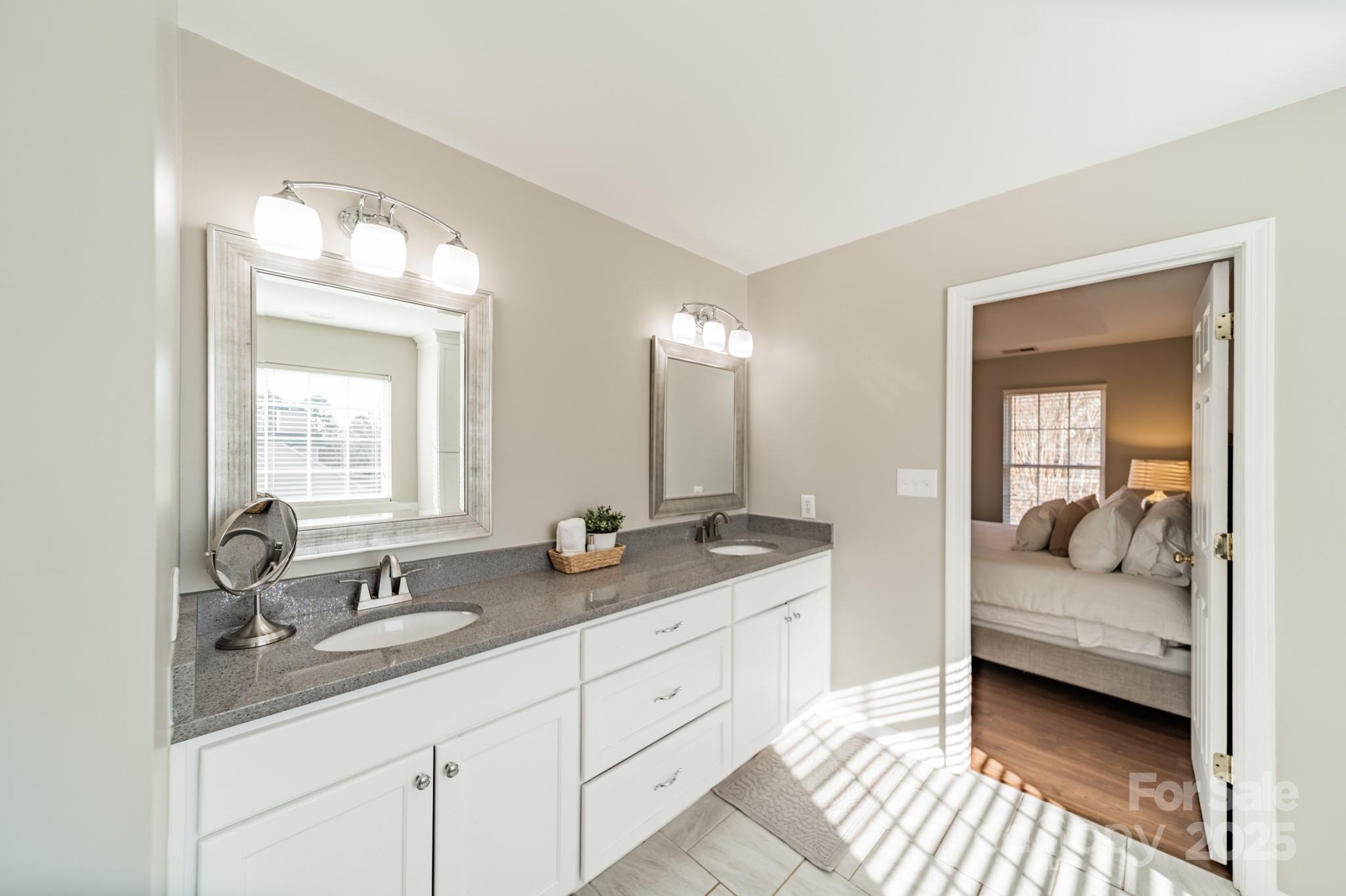 16104 Hollingbourne Road Huntersville, NC 28078 - Photo 29 of 40 a en suite bathroom with double sink and a mirror