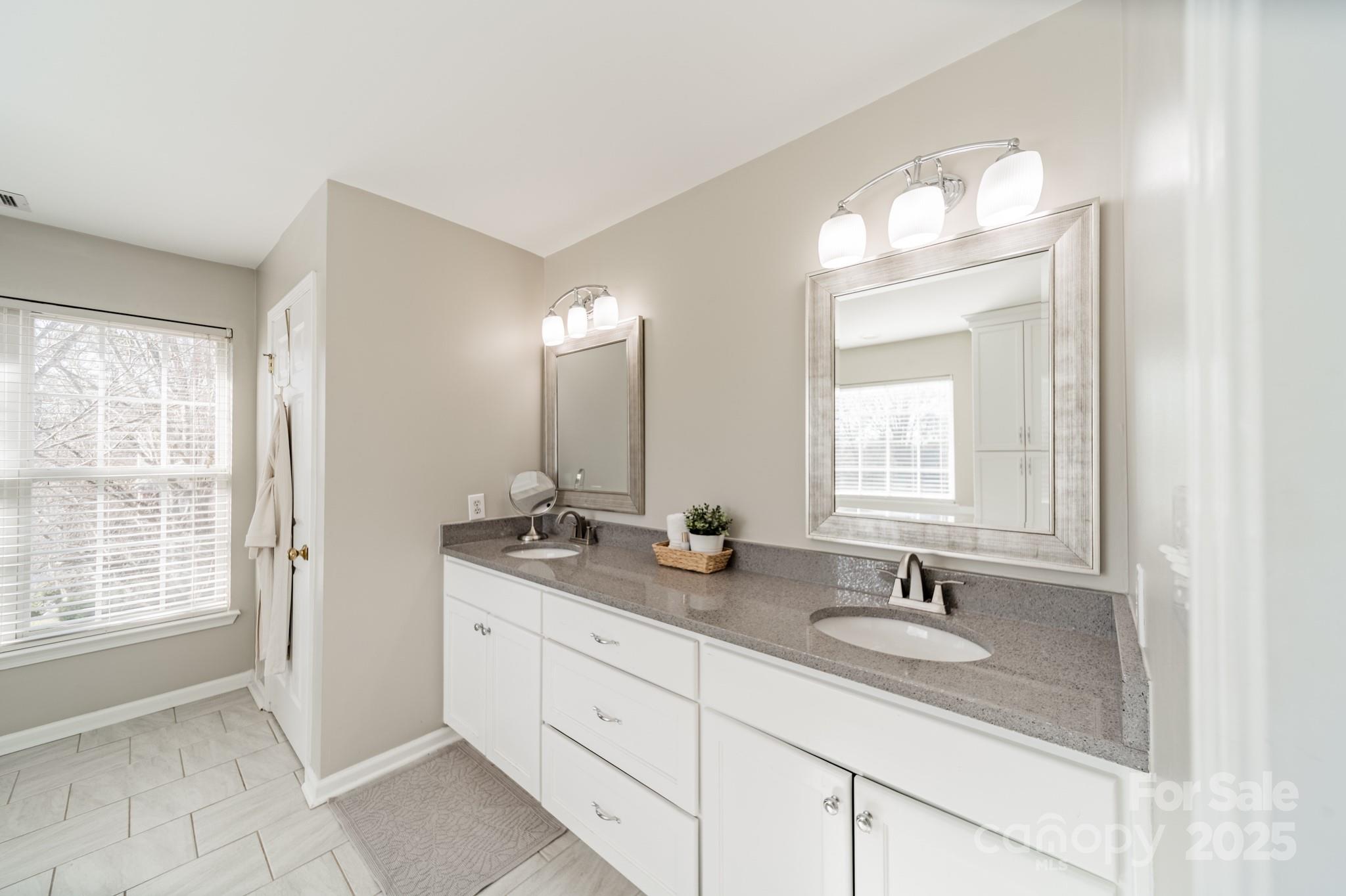 16104 Hollingbourne Road Huntersville, NC 28078 - Photo 30 of 40 a bathroom with double sink and a mirror