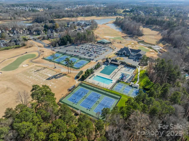 an aerial view of a house with a yard and lake view