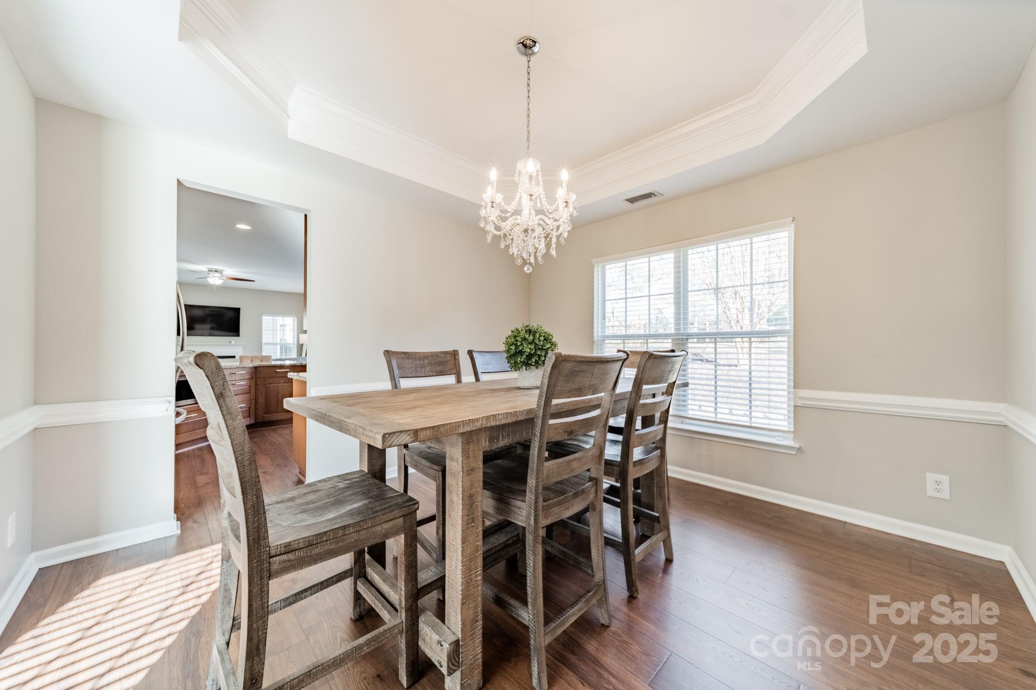 16104 Hollingbourne Road Huntersville, NC 28078 - Photo 9 of 40 a view of a dining room with furniture window and wooden floor