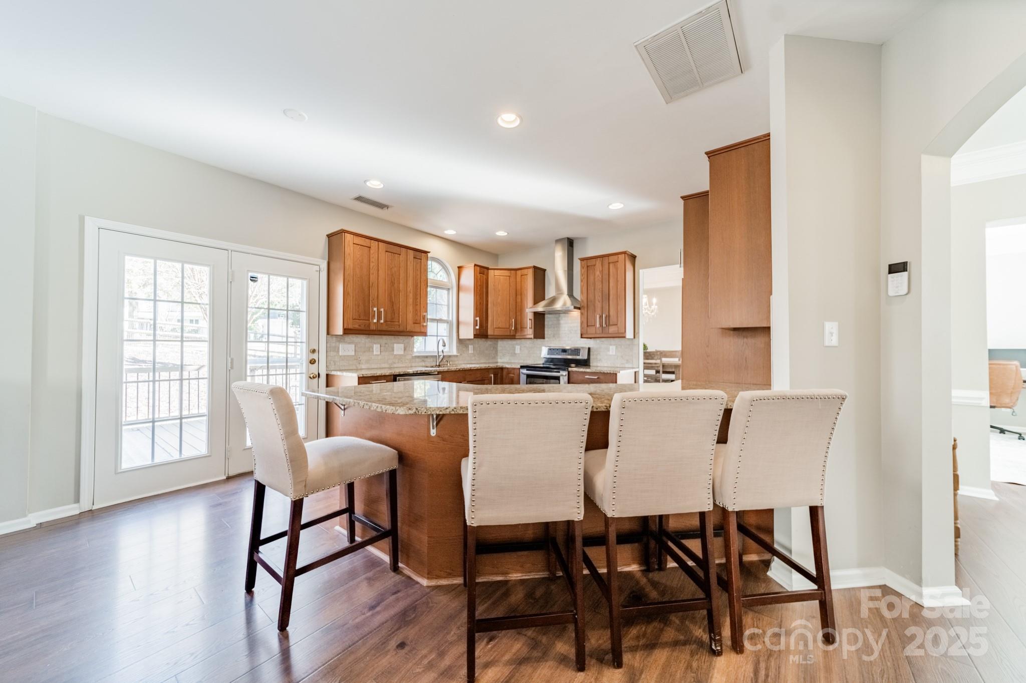 16104 Hollingbourne Road Huntersville, NC 28078 - Photo 10 of 40 a view of a dining room with furniture and wooden floor