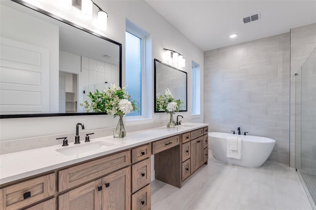 3849 Hawick Lane Dallas, TX 75220 - Photo 13 of 18 Spa-like primary bathroom with a freestanding bath, a large walk-in shower, double vanity, tile walls, and recessed lighting