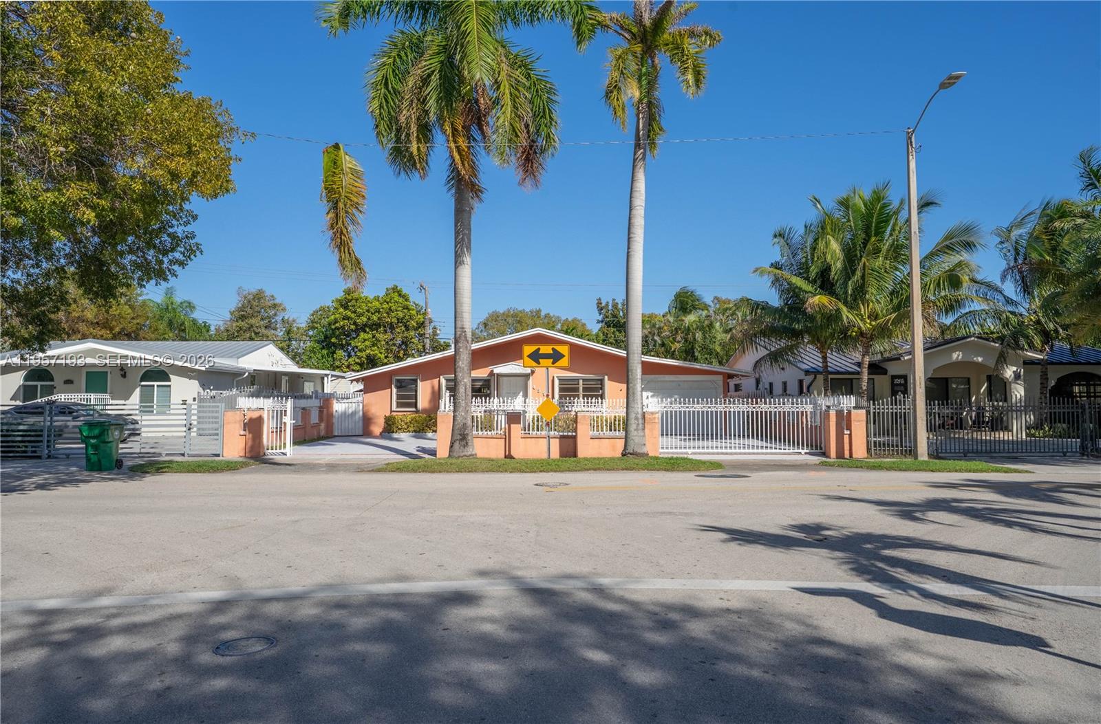 4381 Southwest 5th Terrace Miami, FL 33134 - Photo 30 of 34 a view of a house with a yard and palm trees