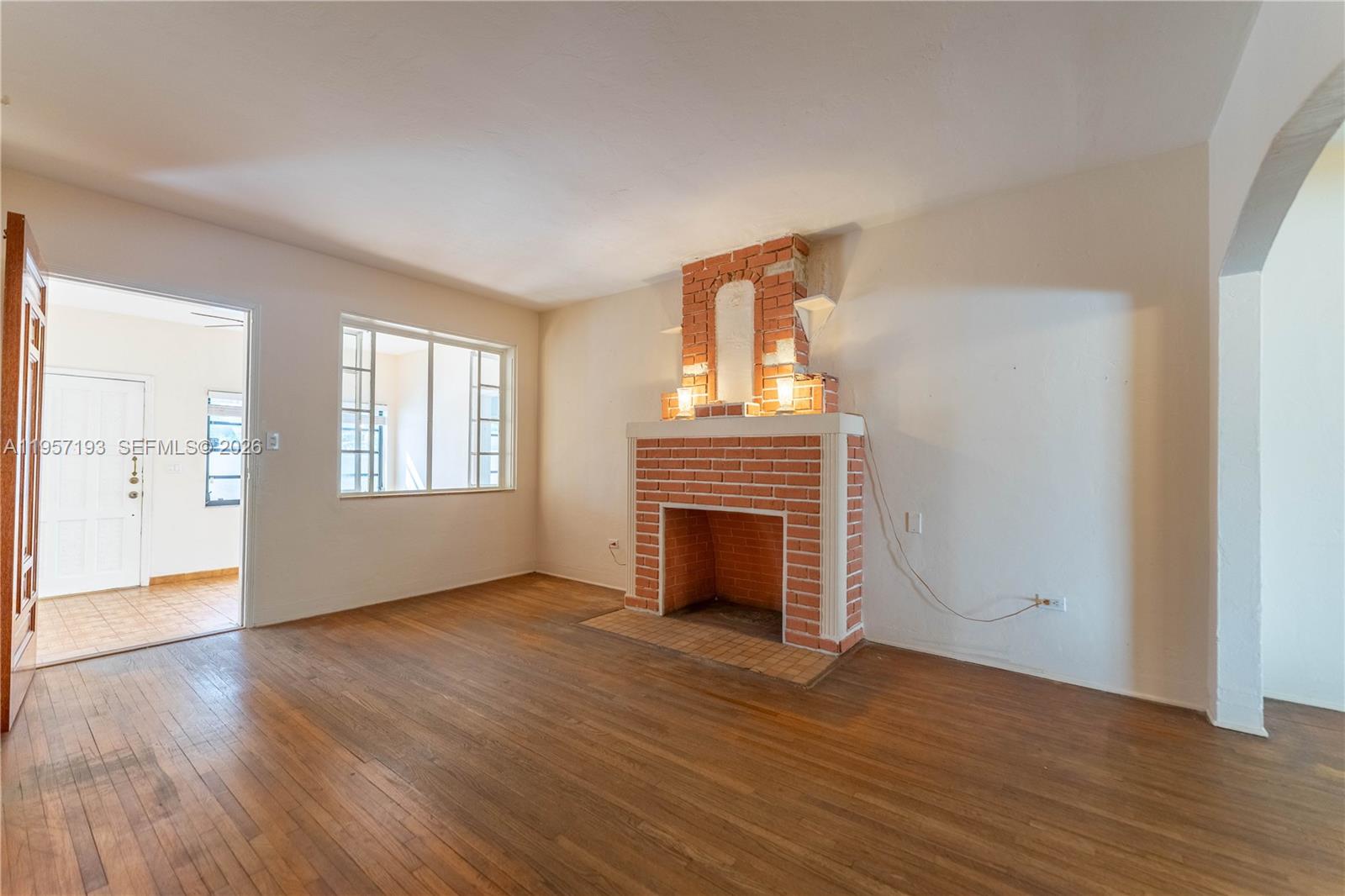4381 Southwest 5th Terrace Miami, FL 33134 - Photo 6 of 34 an empty room with wooden floor fireplace and windows