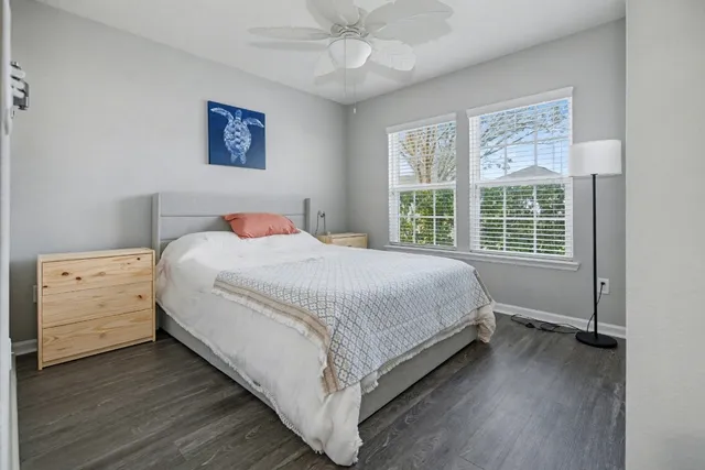 a bedroom with a bed and wooden floor
