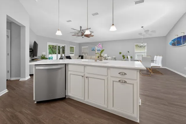 a kitchen with appliances a sink and cabinets