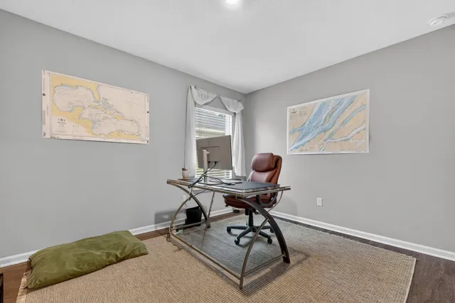 a view of a hallway with wooden floor and closet