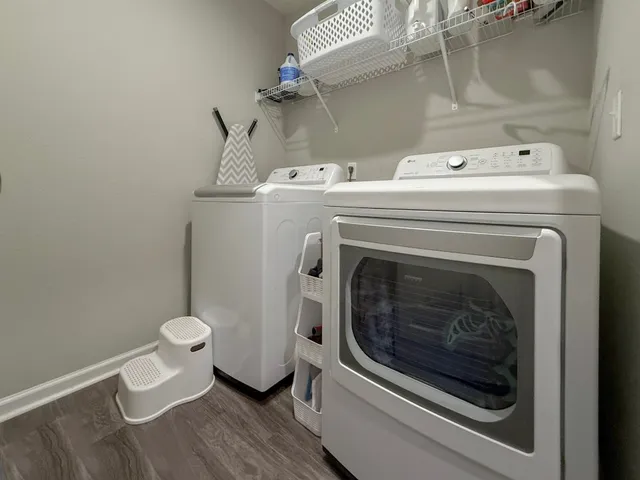 a spacious bathroom with a granite countertop sink a toilet and a mirror