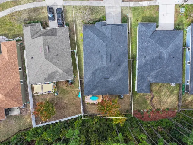 an aerial view of a house with a yard