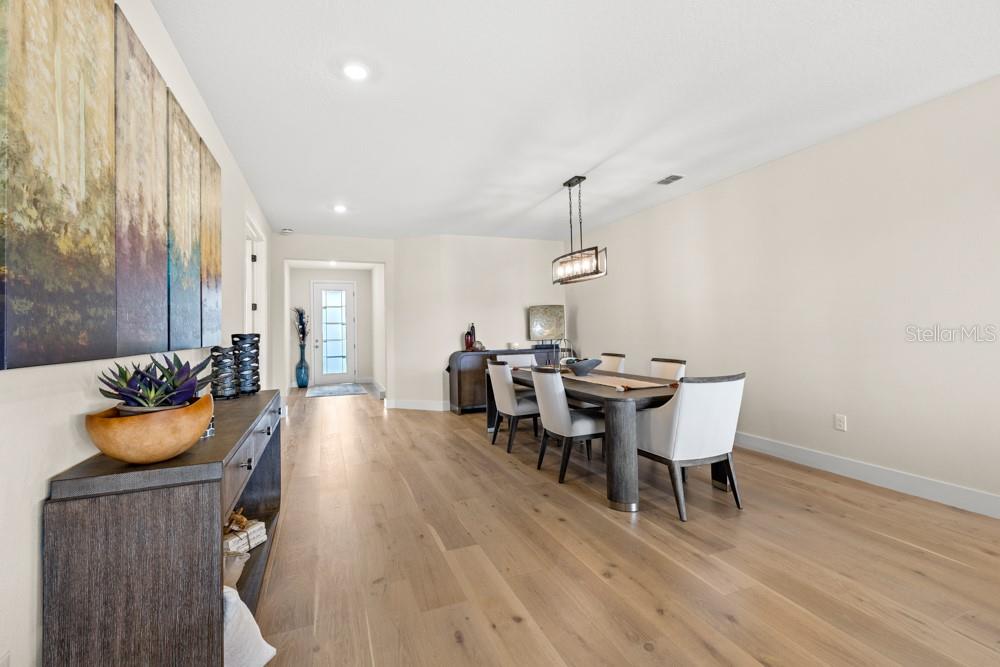 5148 Foothills Preserve Loop Mount Dora, FL 32757 - Photo 16 of 54 a view of a dining room with furniture and wooden floor