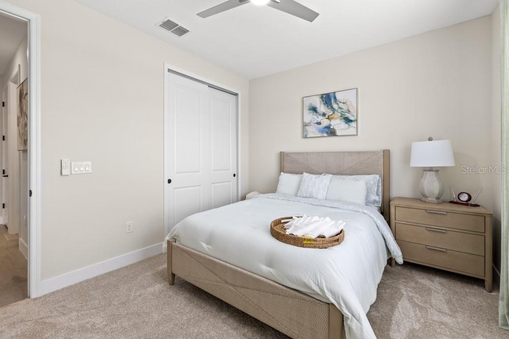 5148 Foothills Preserve Loop Mount Dora, FL 32757 - Photo 20 of 54 a bedroom with a bed and a chandelier