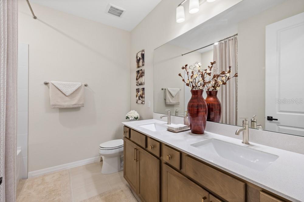 5148 Foothills Preserve Loop Mount Dora, FL 32757 - Photo 21 of 54 a bathroom with a double vanity sink mirror and toilet
