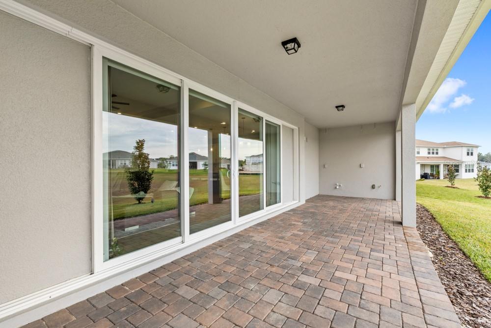 5148 Foothills Preserve Loop Mount Dora, FL 32757 - Photo 34 of 54 a view of an empty room with a floor to ceiling window and wooden floor