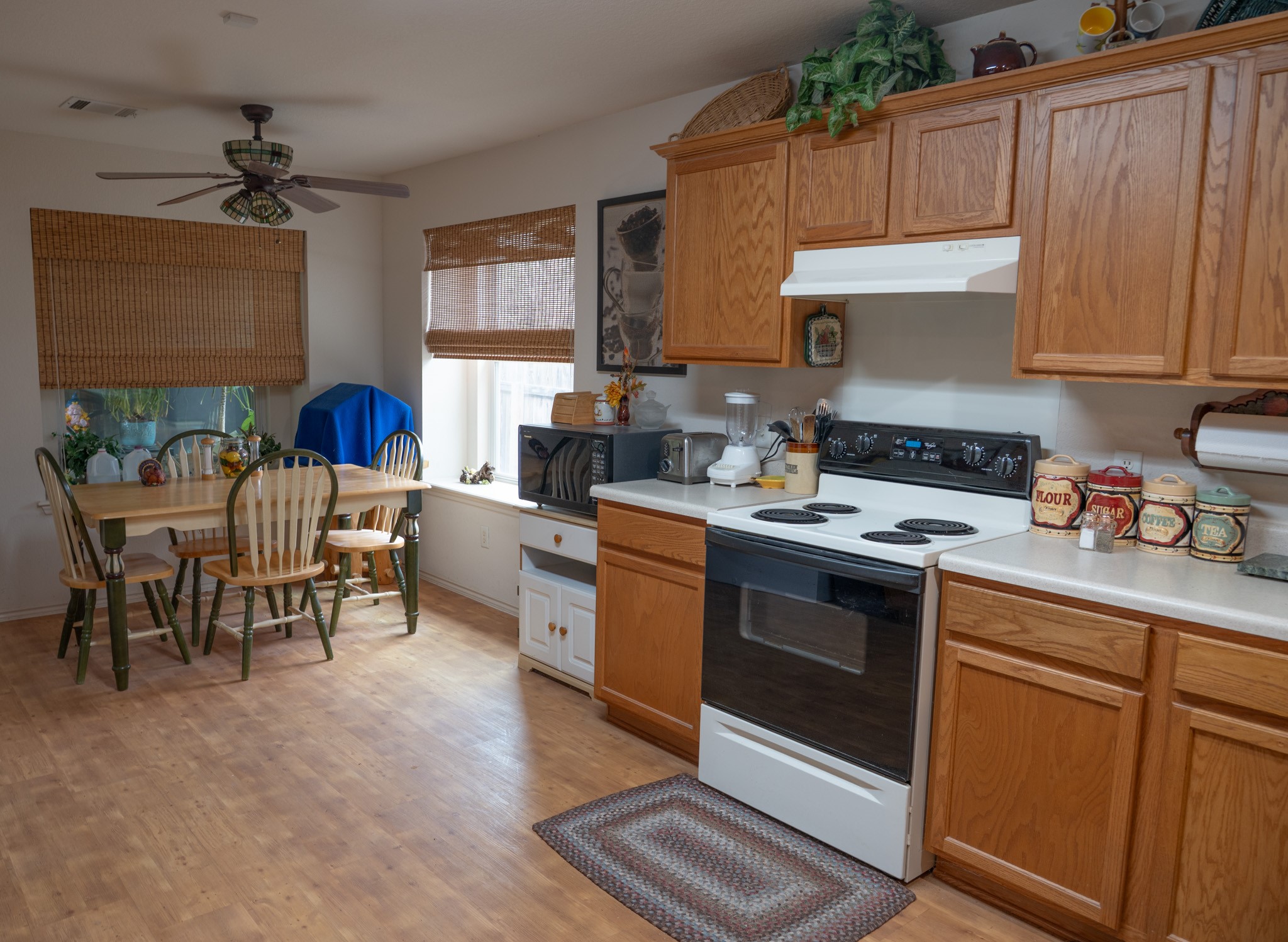 812 Battenburg Trail Pflugerville, TX 78660 - Photo 5 of 29 The open kitchen flows beautifully into the dining area, offering generous cabinet space, abundant storage, and delightful window seats that enhances the home’s inviting atmosphere.