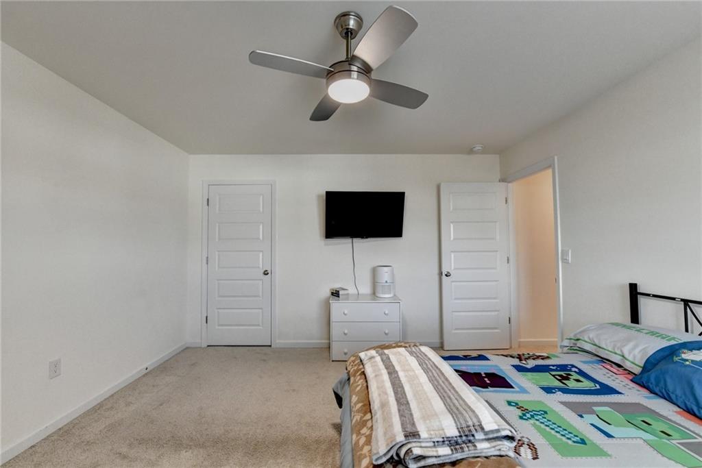86 Canyon Ferry Way Hoschton, GA 30548 - Photo 16 of 61 a bedroom with bed and a flat screen tv
