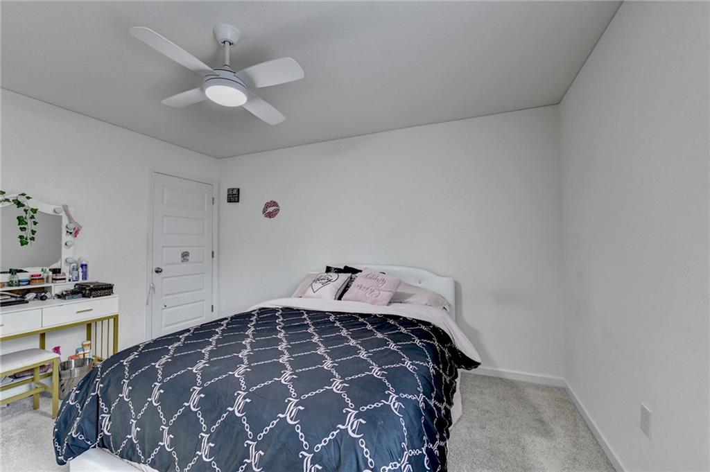 86 Canyon Ferry Way Hoschton, GA 30548 - Photo 20 of 61 a bedroom with a bed and a cabinets