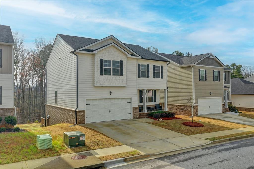 86 Canyon Ferry Way Hoschton, GA 30548 - Photo 2 of 61 a front view of a house with garden