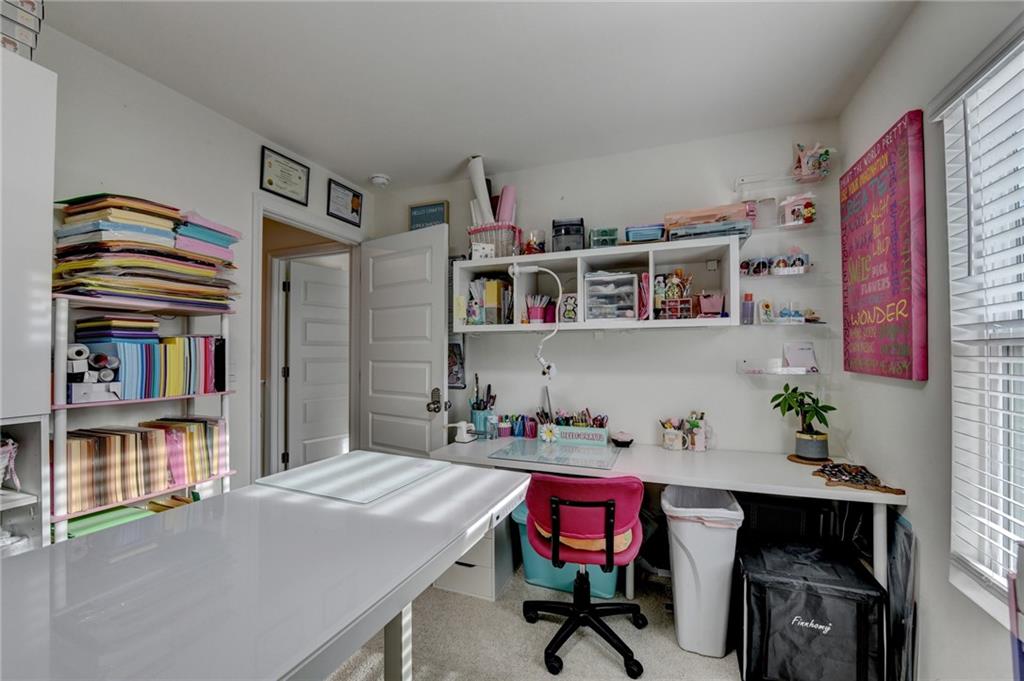86 Canyon Ferry Way Hoschton, GA 30548 - Photo 23 of 61 a room with furniture a bookshelf and a window