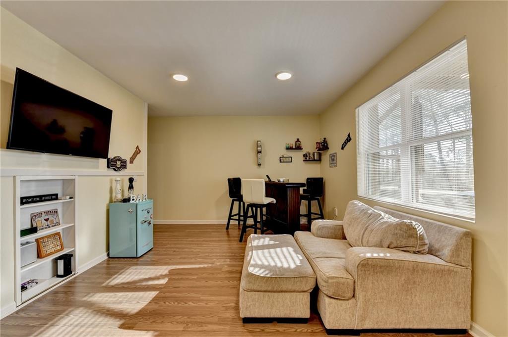 86 Canyon Ferry Way Hoschton, GA 30548 - Photo 24 of 61 a living room with furniture and a flat screen tv