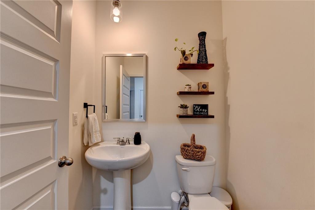 86 Canyon Ferry Way Hoschton, GA 30548 - Photo 29 of 61 a bathroom with a sink a toilet and a mirror