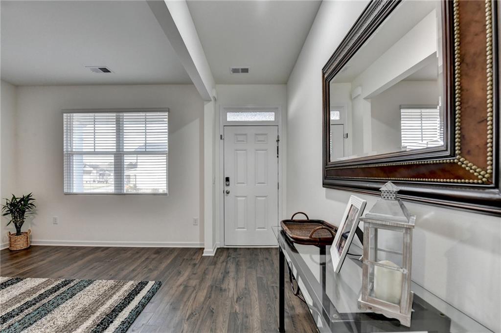 86 Canyon Ferry Way Hoschton, GA 30548 - Photo 3 of 61 a view of a room with wooden floor and chair