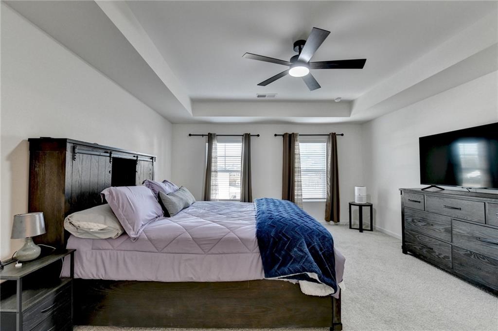 86 Canyon Ferry Way Hoschton, GA 30548 - Photo 33 of 61 a bedroom with a bed and a flat screen tv