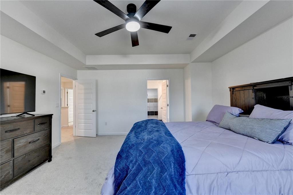 86 Canyon Ferry Way Hoschton, GA 30548 - Photo 35 of 61 a bedroom with a bed and a flat screen tv