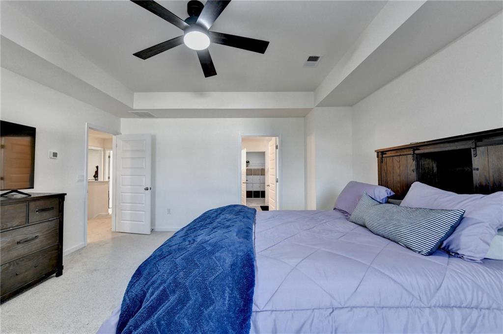 86 Canyon Ferry Way Hoschton, GA 30548 - Photo 36 of 61 a bedroom with a large bed and a flat screen tv