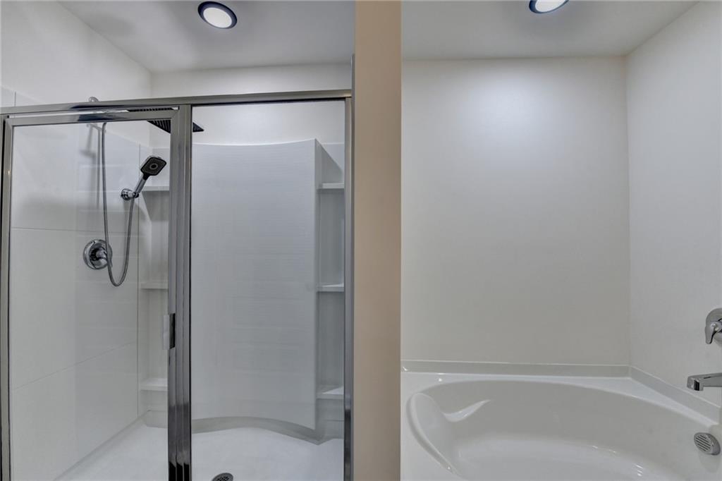 86 Canyon Ferry Way Hoschton, GA 30548 - Photo 39 of 61 a bathroom with a shower and a bath tub