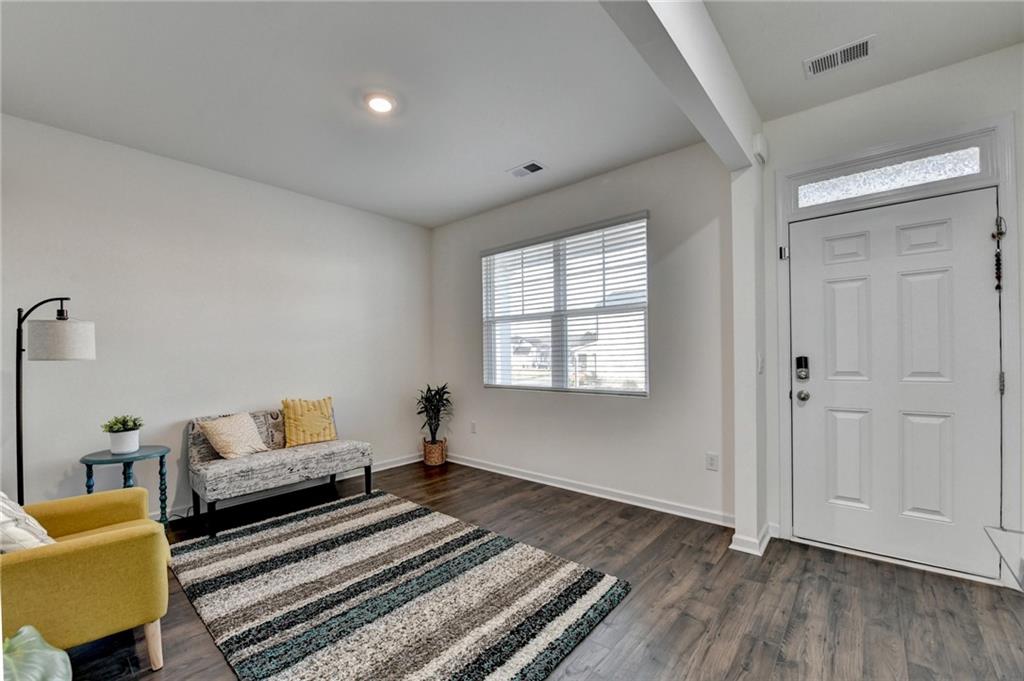86 Canyon Ferry Way Hoschton, GA 30548 - Photo 4 of 61 a living room with furniture and a rug