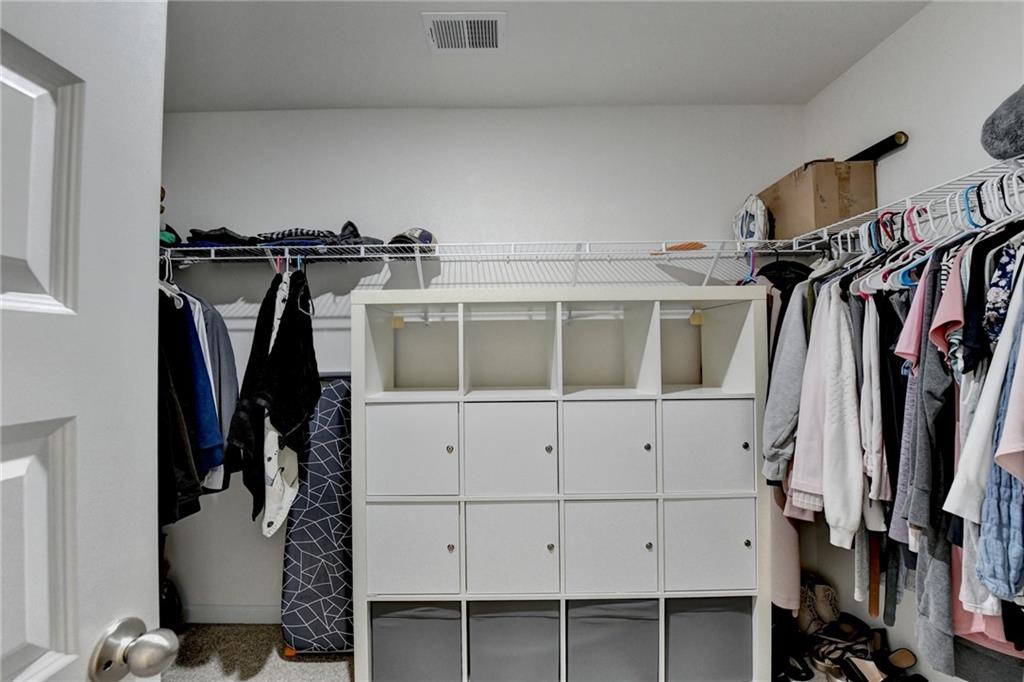 86 Canyon Ferry Way Hoschton, GA 30548 - Photo 41 of 61 a view of walk in closet with clothes and shoes