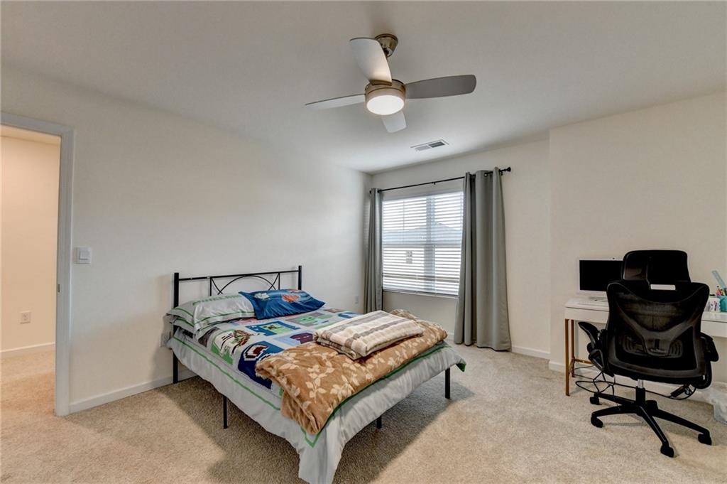 86 Canyon Ferry Way Hoschton, GA 30548 - Photo 42 of 61 a bedroom with a bed and a desk