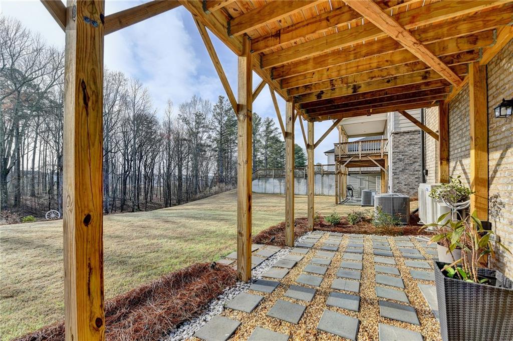 86 Canyon Ferry Way Hoschton, GA 30548 - Photo 48 of 61 a view of a pathway door with wooden floor