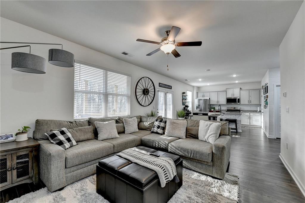 86 Canyon Ferry Way Hoschton, GA 30548 - Photo 8 of 61 a living room with furniture a clock and a window