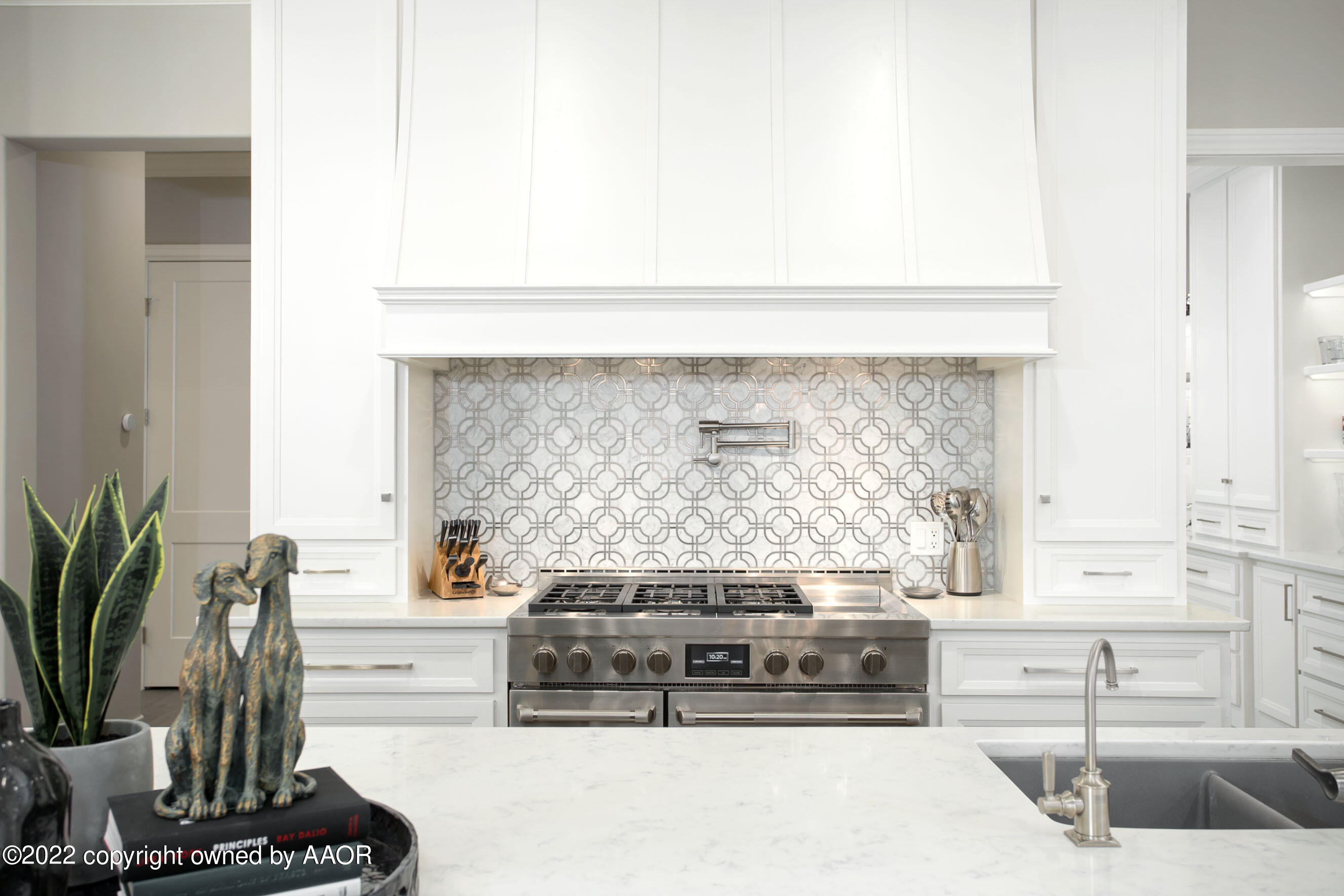 9101 Blackhawk Road Amarillo, TX 79119 - Photo 11 of 73 a kitchen with a stove and a white cabinet