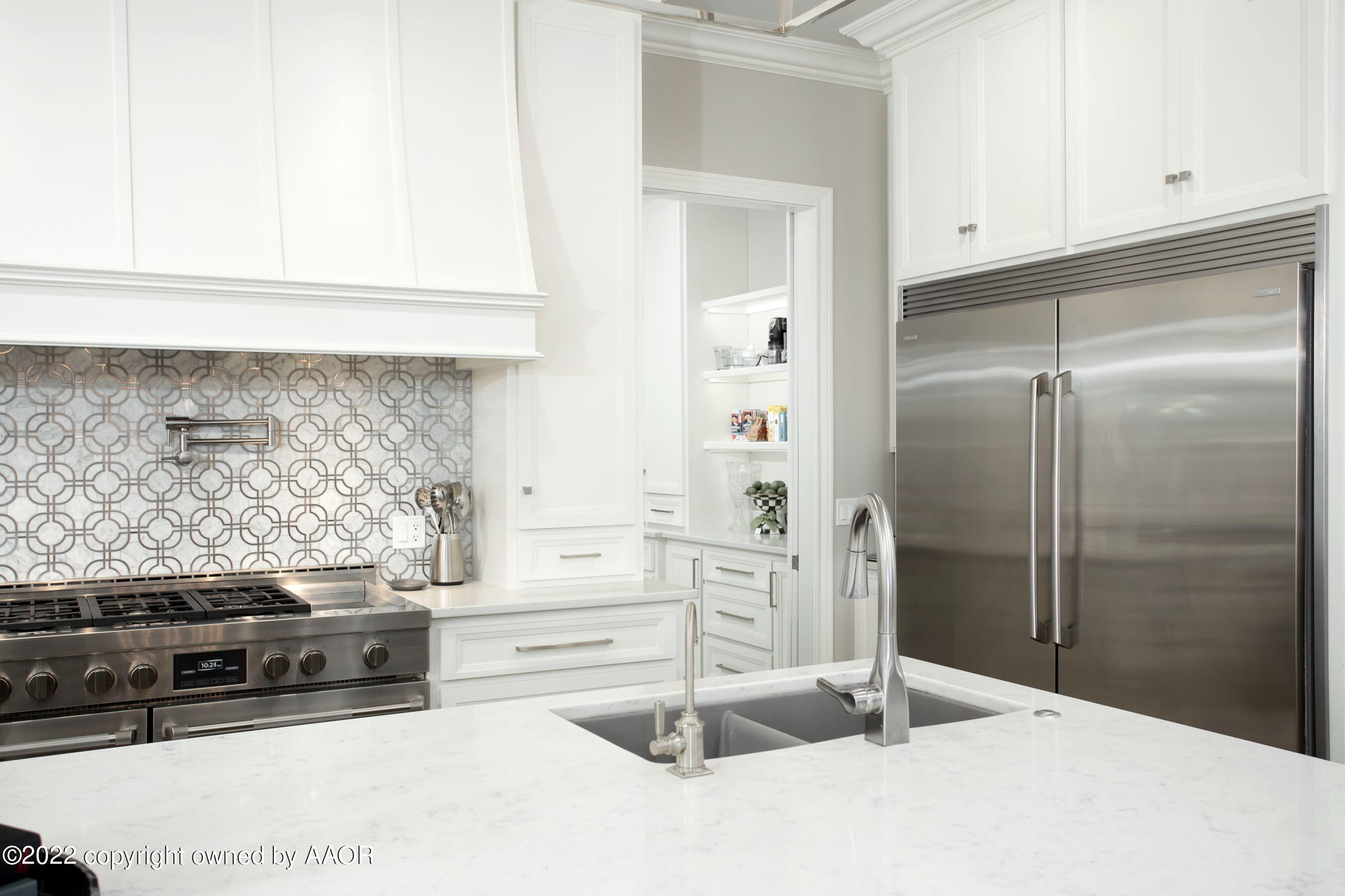 9101 Blackhawk Road Amarillo, TX 79119 - Photo 12 of 73 a kitchen with stainless steel appliances kitchen island granite countertop a refrigerator and a stove
