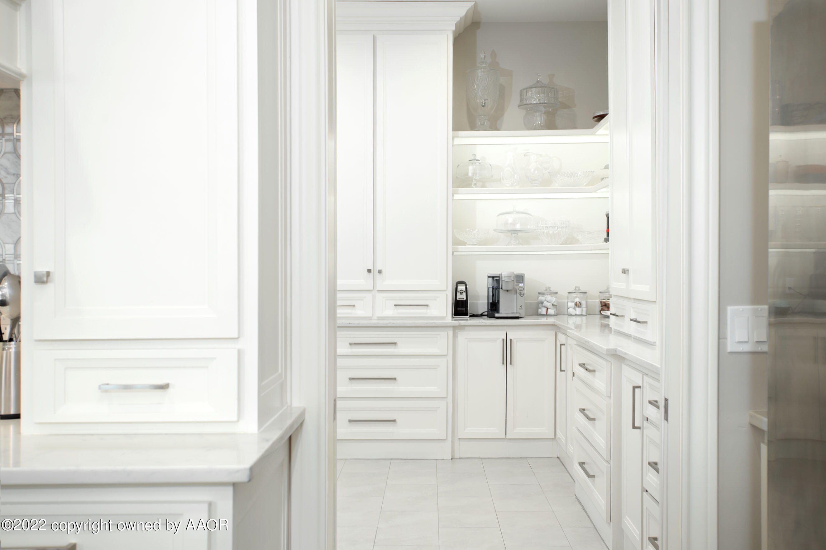 9101 Blackhawk Road Amarillo, TX 79119 - Photo 13 of 73 a kitchen with white cabinets and a window
