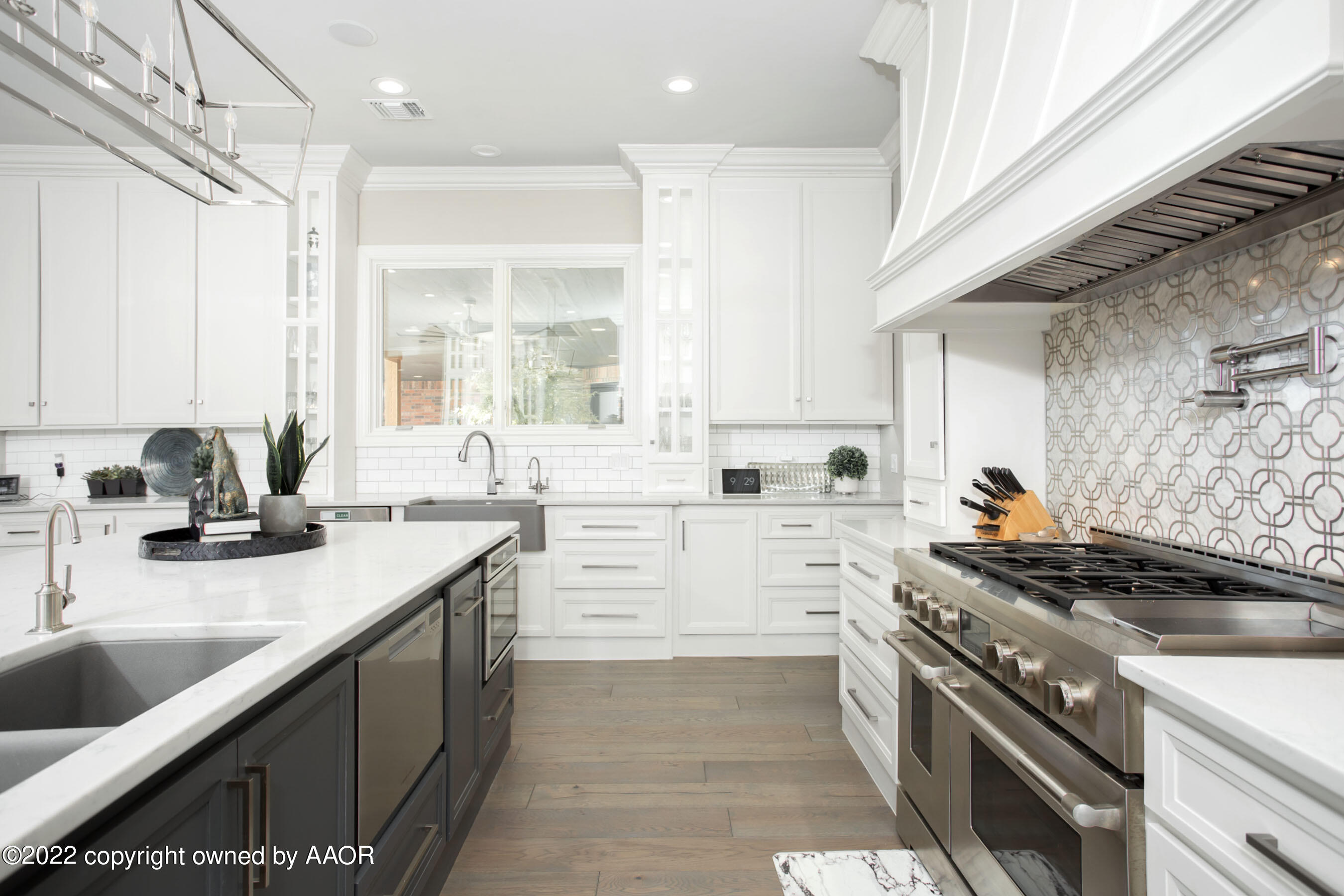 9101 Blackhawk Road Amarillo, TX 79119 - Photo 14 of 73 a kitchen with a sink stove top oven and cabinets