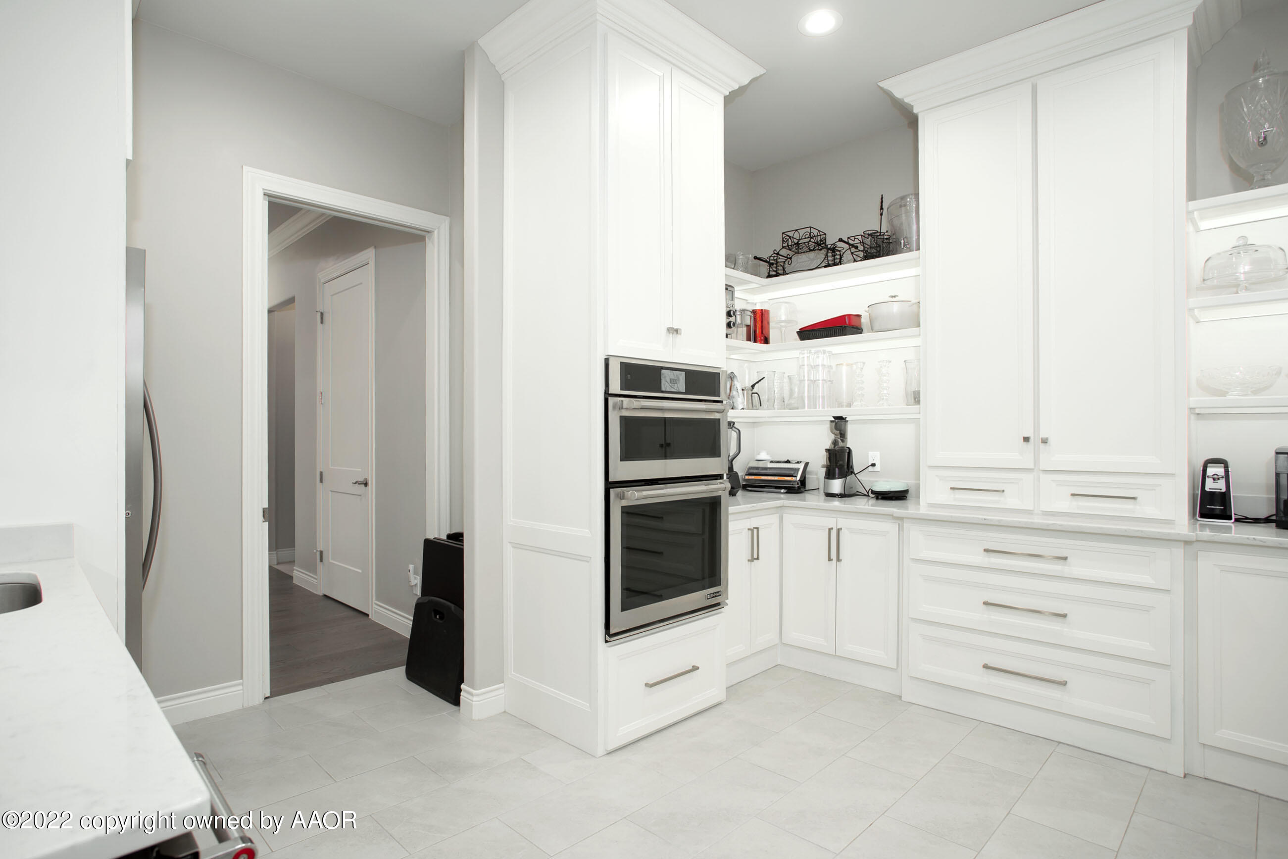 9101 Blackhawk Road Amarillo, TX 79119 - Photo 16 of 73 a kitchen with cabinets and white appliances